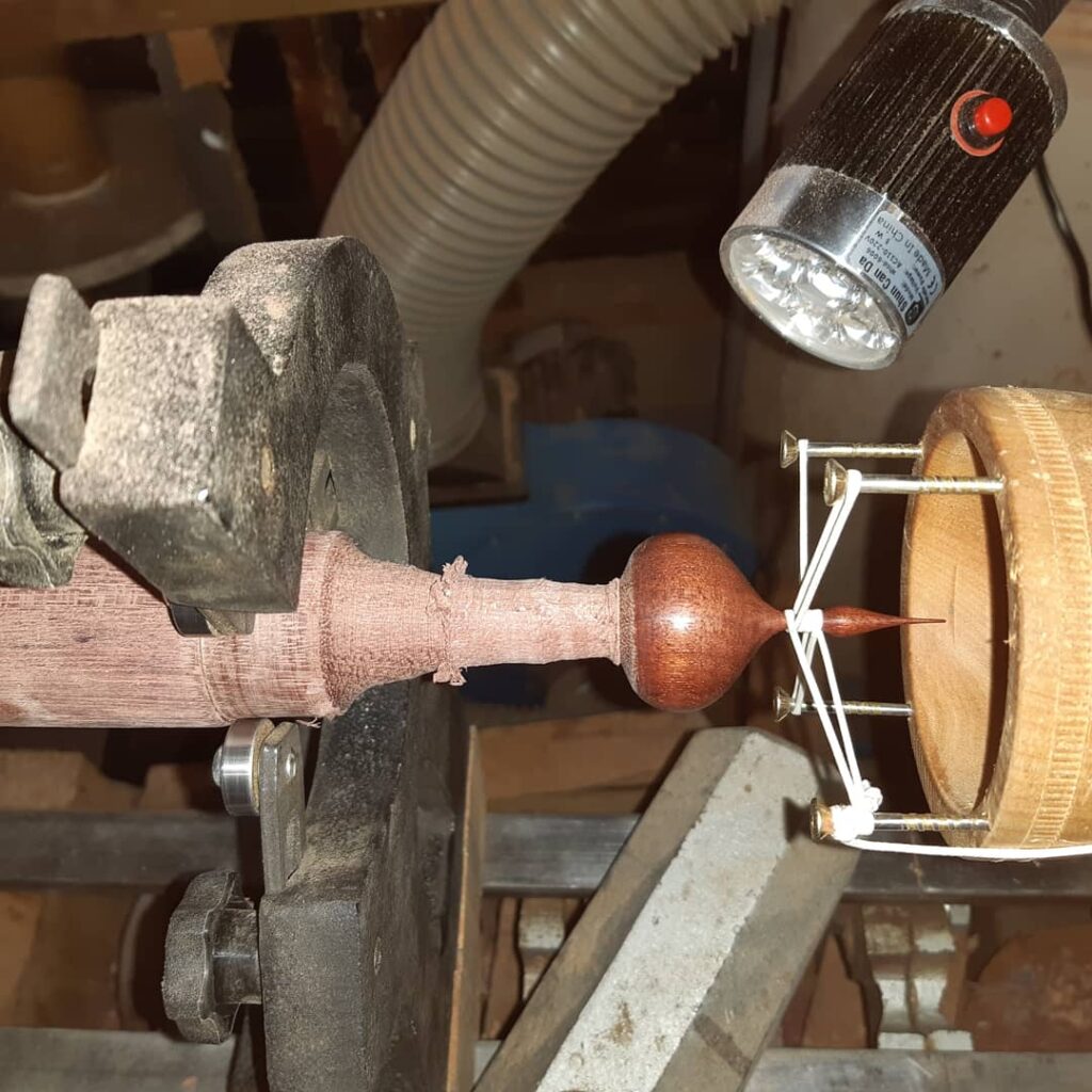Use a string steady in the tail stock to steady and protect the finial