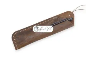 A high-quality leather pen sleeve with a detailed flower pattern embossed on its surface.