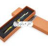 Orange paper pen box with a decorative pattern and a sponge insert for storing a handmade wooden pen.