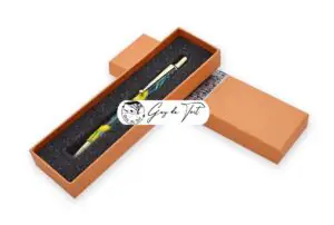 Orange paper pen box with a decorative pattern and a sponge insert for storing a handmade wooden pen.