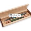 A maple wooden pen box with dark side panels, designed for two handcrafted pens or a pen and pencil set.