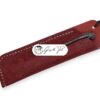 A high-quality leather pen sleeve with a detailed flower pattern embossed on its surface.