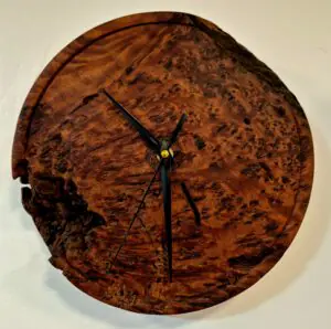 Master-turned Totara Burl Wall Clock by Guy du Toit, showing rare Birds Eye figuring and weathered, unfinished exterior contrast.