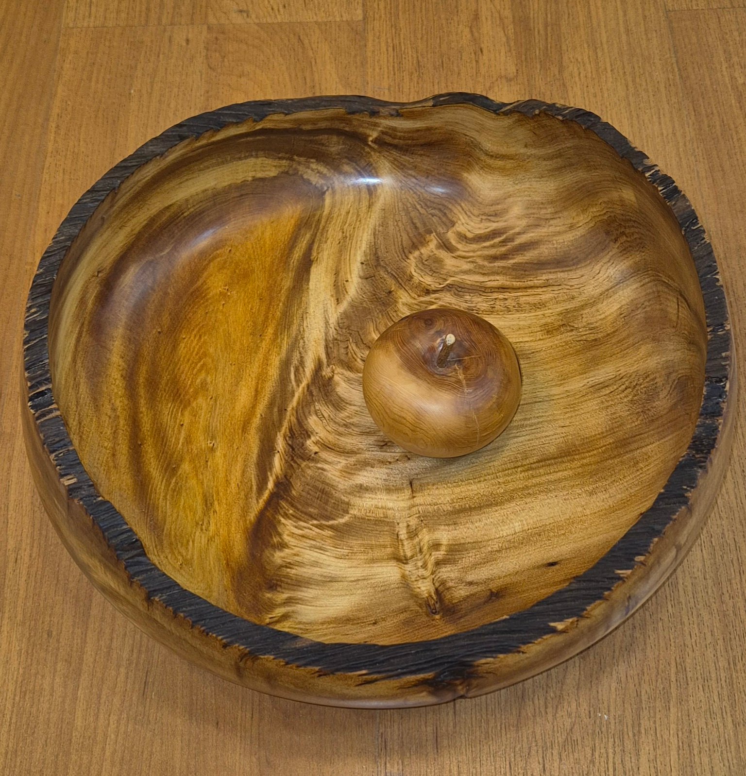 Ancient swamp kauri bowl with charred rim handcrafted by Guy du Toit with apple for scale