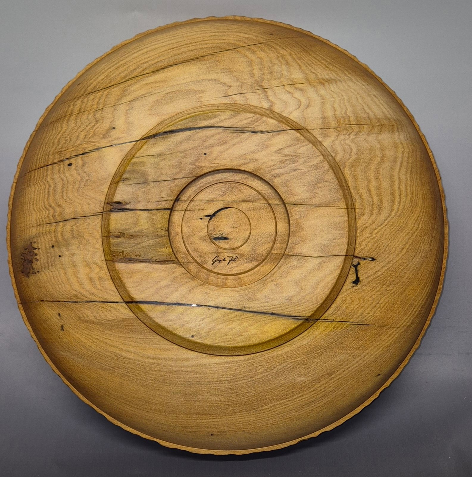 Back view of handcrafted swamp kauri bowl with carved wave rim