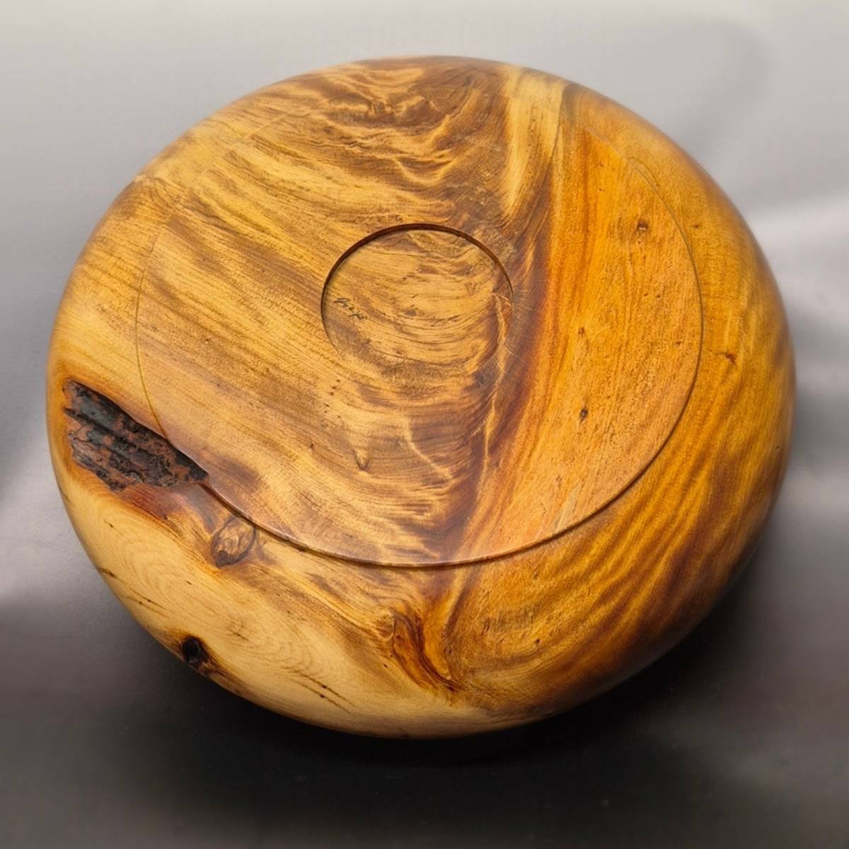 Back view of handcrafted swamp kauri bowl with natural golden grain